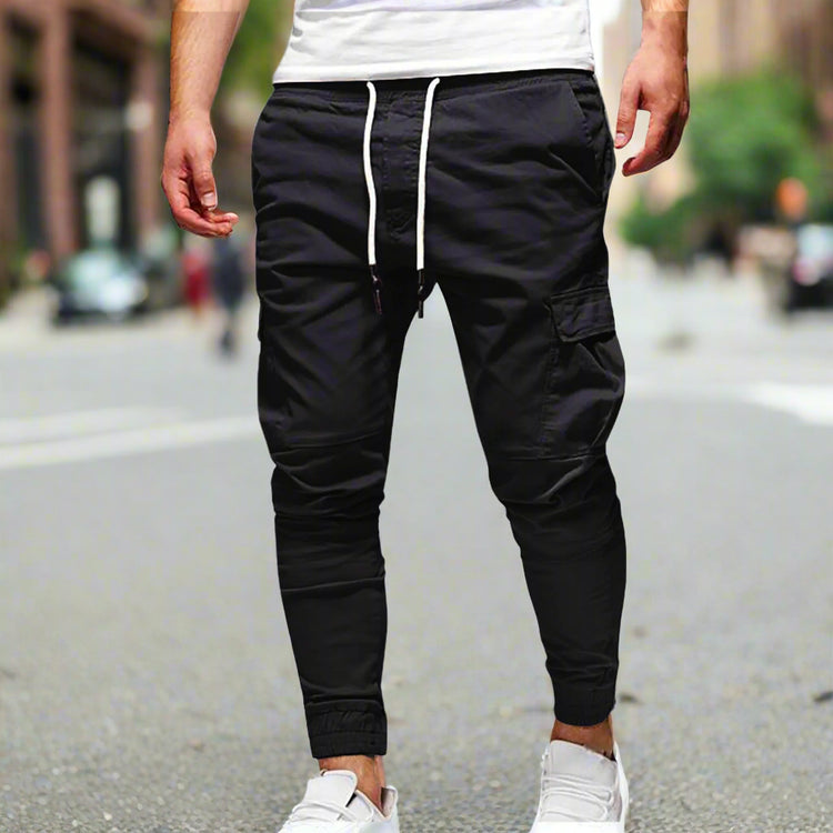Black jogger pants with white drawstring on a white background
