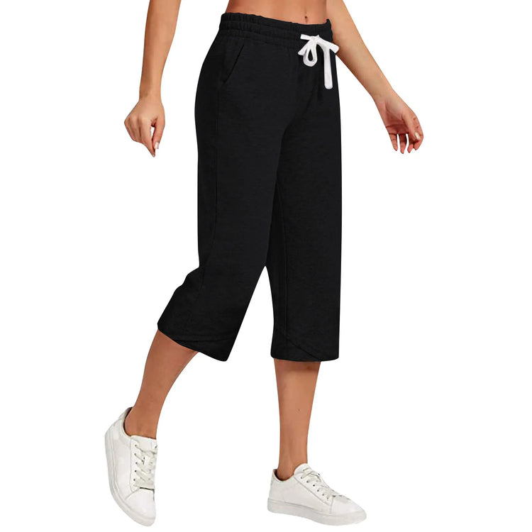 Black capri pants with a drawstring waist worn by a person on a white background