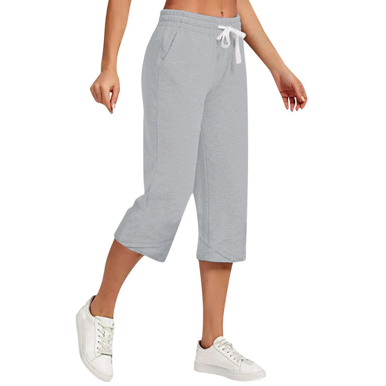Gray sweatpants worn by a person on a white background