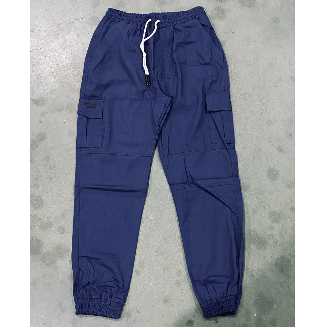 Blue cargo pants on a gray concrete floor