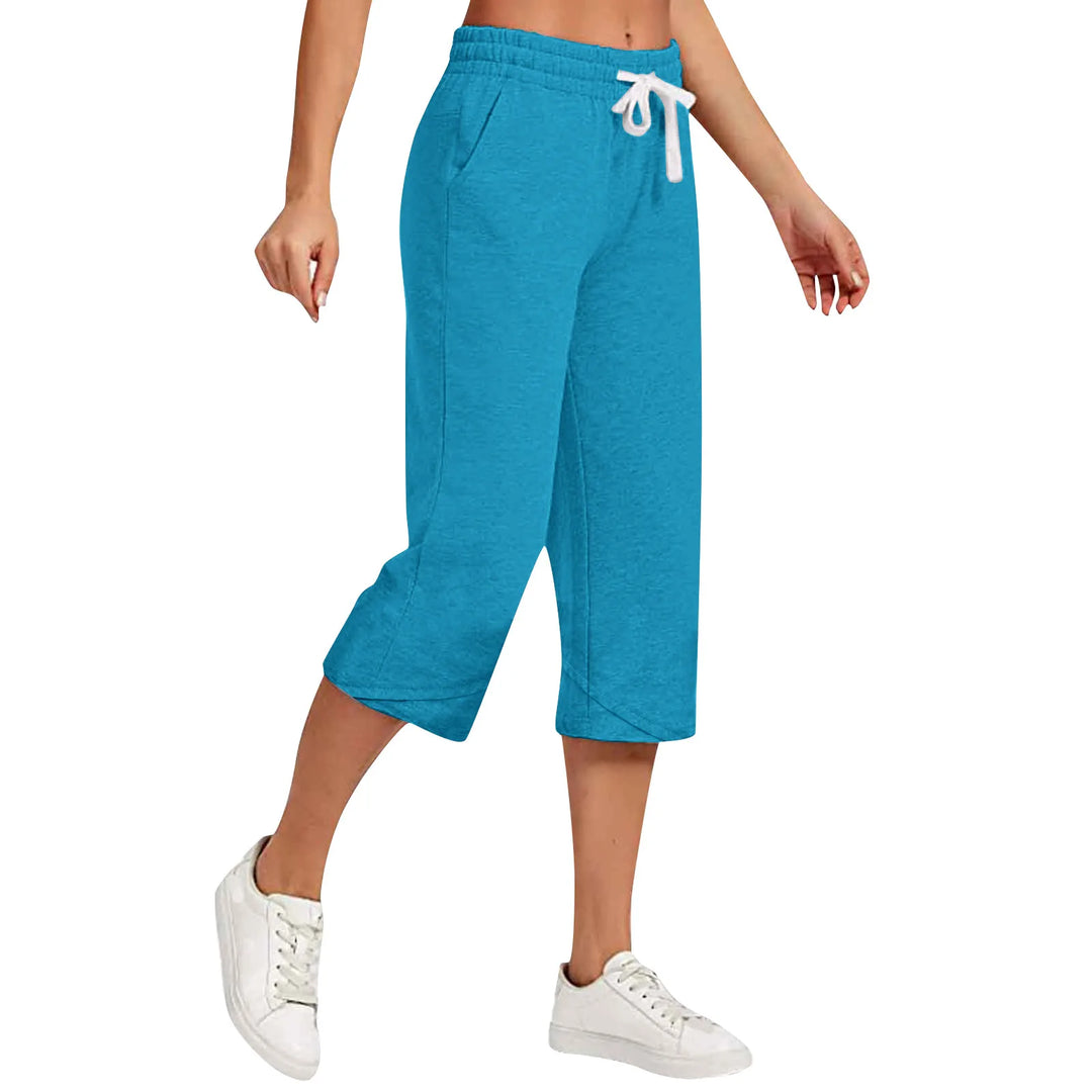 Blue capri pants worn by a person on a white background