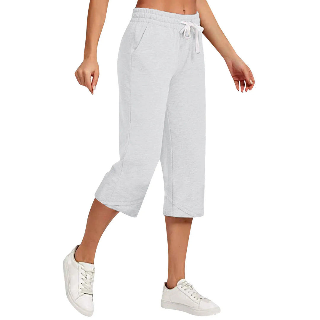 Light gray sweatpants worn by a person on a white background