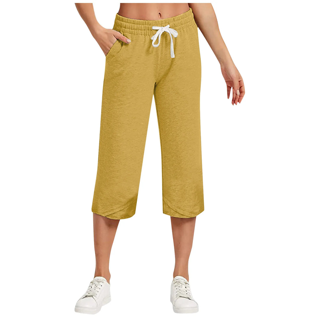 Mustard yellow capri pants with a white drawstring on a white background