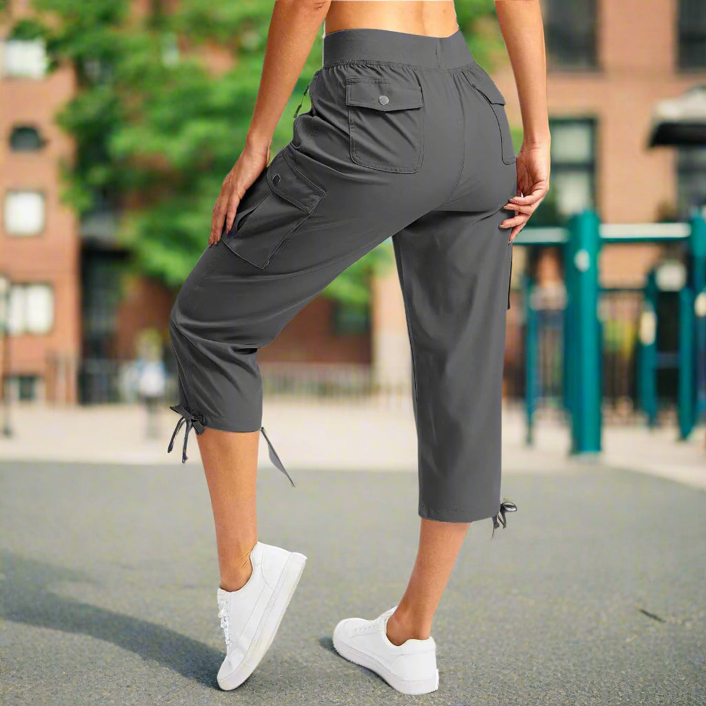 Person wearing gray capri pants on a white background