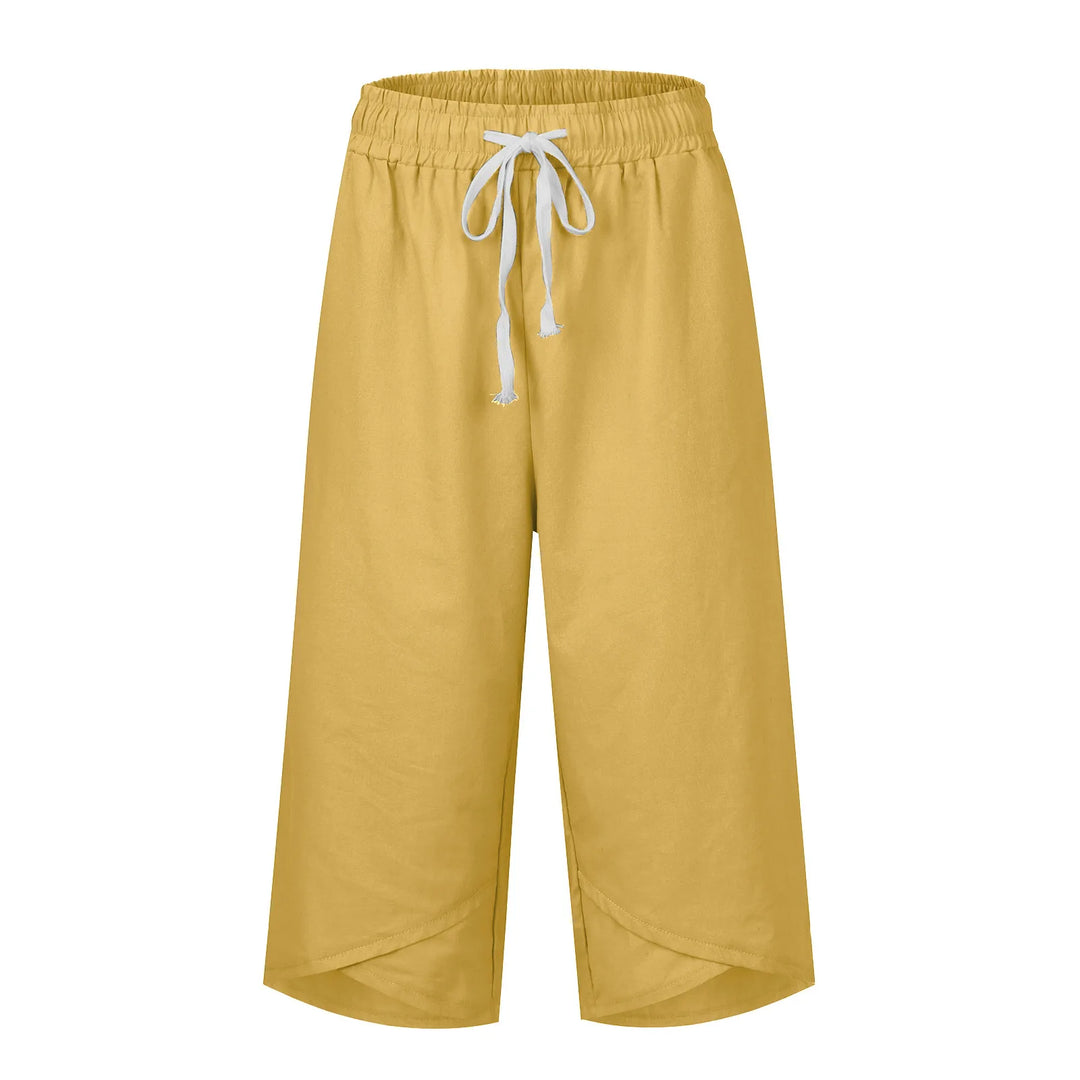 Mustard yellow pants with a white drawstring on a white background